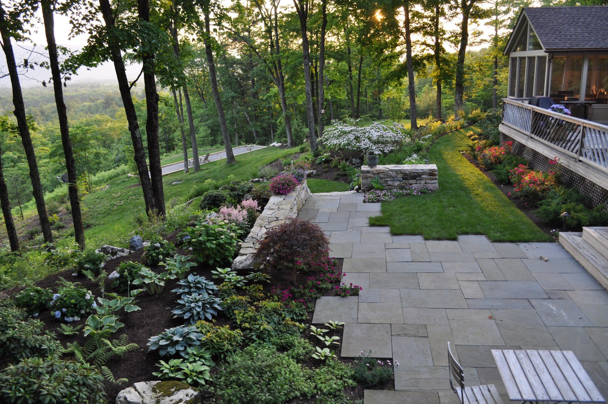 Bluestone terrace and layered plantings at golden hour